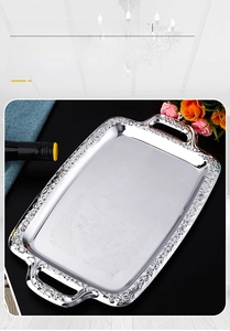 Detailed top view of a silver stainless steel rectangular tray with ornate bird carvings