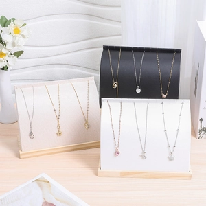 Velvet necklace display stands with various gold and silver heart pendants in three colors
