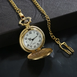Elegant gold quartz pocket watch with mosque flip cover on textured vintage background
