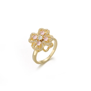 Detailed view of flower-shaped ring with gold plating and pink zirconia stones