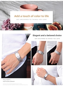 Detail view of men's stainless steel Cuban chain bracelet with engraved cross plate