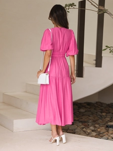 Detail of rose pink textured dress with back zipper, puff sleeves and pleated waist
