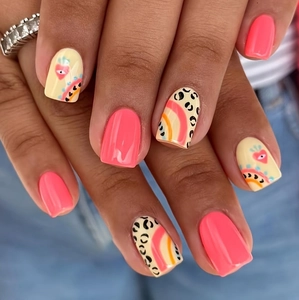 Press-on nail kit featuring neon pink, leopard print, and heart eye graphic designs