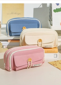 Detailed stack of multi-layer canvas pencil cases in pastel blue, beige, and pink colors