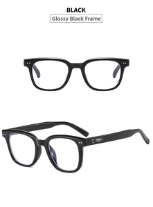 Detailed view of glossy black square sunglasses frames featuring retro metal rivets