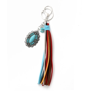 Detail of western style turquoise pendant keychain with colorful leather tassels