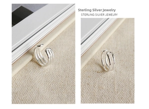 Close-up of triple-layered S925 sterling silver ear cuffs with minimalist chic design