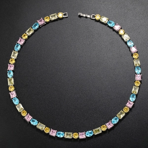 Detail showing multi-color zircon tennis necklace with silver base on dark background
