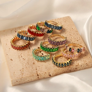 Elegant gold plated copper rings set with colorful cubic zirconia on stone and silk