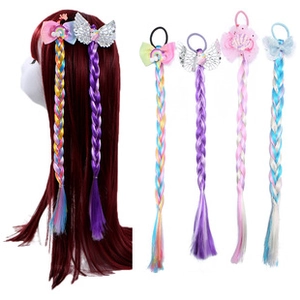 Detail of girls' colorful wig hair clips featuring cute butterfly and rainbow ornaments
