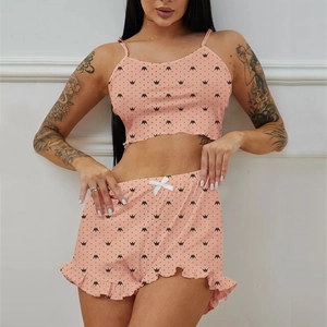 Detail of coral pink pajama set with crown prints, ribbed texture and waist bow