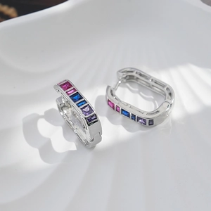 Luxury brass huggie hoop earrings with rectangular colorful zircon inlays on white tray