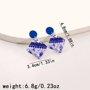 Detail view of blue and white porcelain earrings with precise size and weight measurements