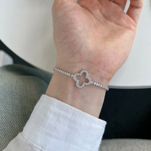 Close-up of S925 sterling silver four-leaf clover tennis bracelet with pavé-set zircons