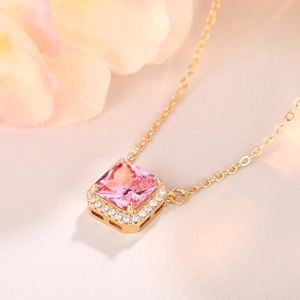Macro shot of a pink square gemstone necklace with sparkling diamond-set frame detail