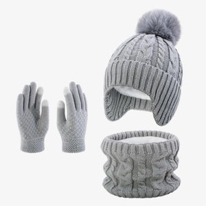 Close-up of gray knit winter set with faux fur pompom, thick fleece lining and touch gloves