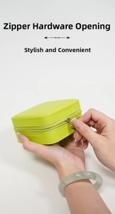Close-up of lime green portable jewelry box in textured PU leather with metal zipper