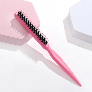 Pink teasing brush with black bristles and ball-tipped pins for hair styling