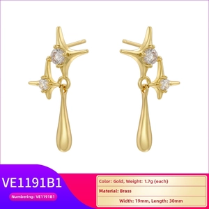 Detailed view of gold starburst and teardrop earrings with cubic zirconia stones