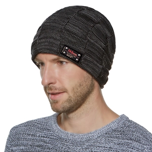 Detailed knit texture of a gray beanie featuring a rectangular leather fashion patch
