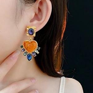 Vintage gold earrings with purple oval gems and orange heart drop pendants