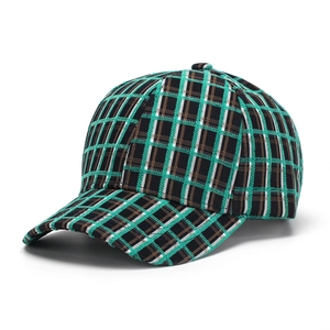 Close-up of green plaid baseball cap showing thick woven fabric and stitching details