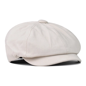 Detailed top view of beige newsboy cap showing stitched panels and center button