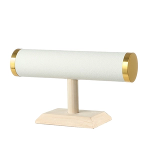 T-bar jewelry stand with white leather cylinder and gold trim on solid wood base