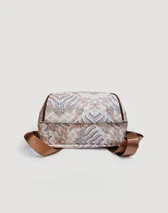 Detail of traditional Chinese wave pattern print on a classic crossbody backpack