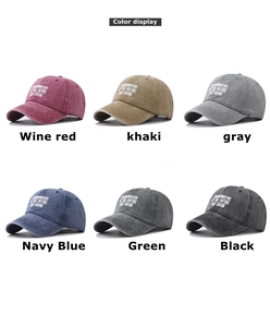 Multiple vintage washed cotton baseball caps in six different colors with art lettering