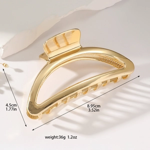 Large golden semi-circular metal hair claw clip with minimalist hollow design for women
