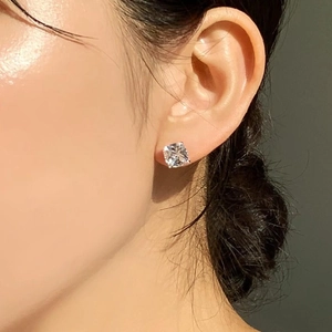 Close-up of cushion-cut cubic zirconia stud earrings in sterling silver on model