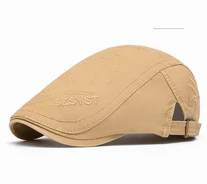 Detail of khaki vintage flat cap with intricate embroidery and metal buckle closure