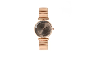 Détail d'une montre à quartz or rose avec bracelet extensible et cadran marron élégant