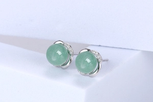 Detail of S925 silver stud earrings with light green jade beads and cubic zirconia