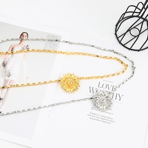 Luxury gold and silver sunflower waist chains for women on a white magazine background