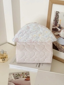 Close-up of heart quilted fabric tissue holder featuring lucky house pattern