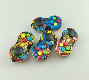 Close-up of four decompression game controller toys with colorful graffiti patterns