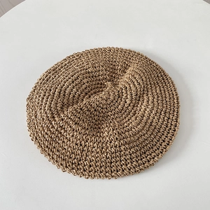 Detailed close-up of handmade crochet texture on a khaki summer beret hat for women