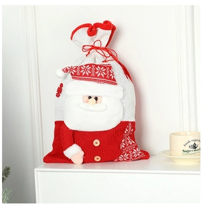 Detail of knitted Santa gift bag with 3D beard and snowflake pattern on white stand