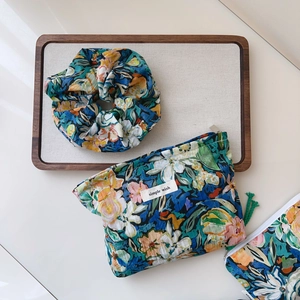 Detail showing oil painting floral cotton pouch and matching scrunchie with label