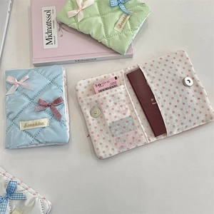 Internal card slots and magnetic snap button detail of the quilted bow passport holder