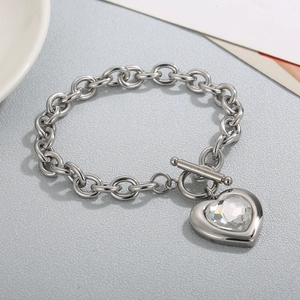 Macro view of silver stainless steel chain bracelet with heart crystal and OT clasp detail