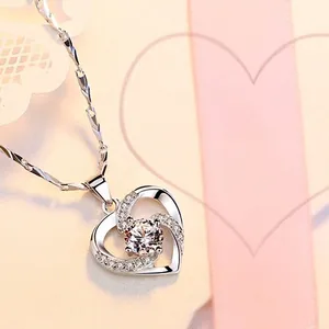 Silver heart pendant necklace with sparkling crystal and twisted chain design for women