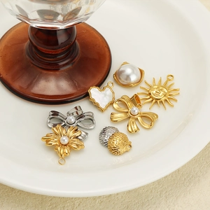 Golden and silver stainless steel charms with pearls and shells in various floral shapes