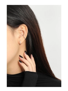 Detail view of S925 sterling silver ear cuff and pavé zircon hoop earring on ear