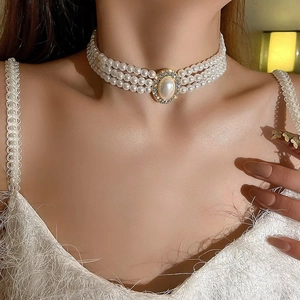 Vintage three-row pearl choker necklace with gold-tone oval rhinestone pendant