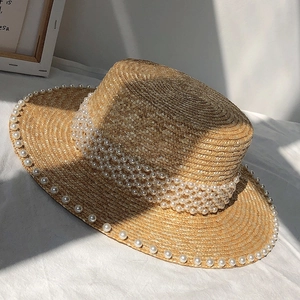 Flat top straw sun hat featuring elegant faux pearl decorations and fine weaving detail