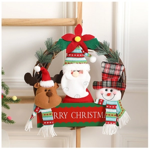 Close-up of Merry Christmas sign on a rattan wreath with holiday plush characters