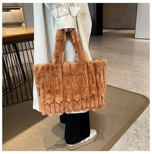 Detail of plush caramel brown tote bag featuring unique vertical stripe embossed texture